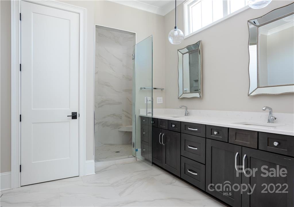 811 Naples Drive Davidson, NC 28036 - Photo 17 of 31 a bathroom with a sink and a mirror