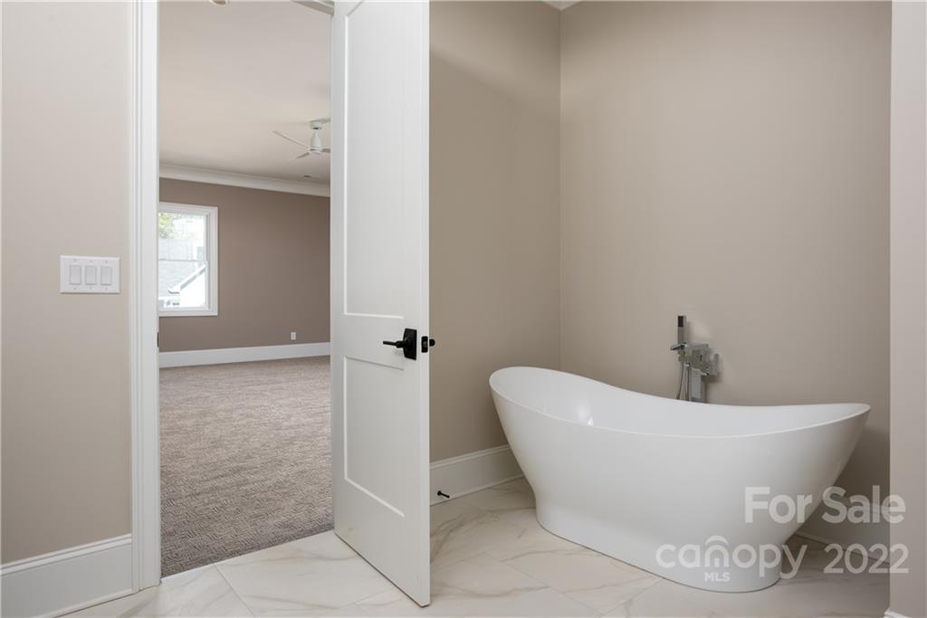 811 Naples Drive Davidson, NC 28036 - Photo 18 of 31 a white bath tub sitting in a bathroom