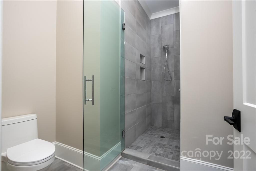 811 Naples Drive Davidson, NC 28036 - Photo 19 of 31 a bathroom with a shower and toilet