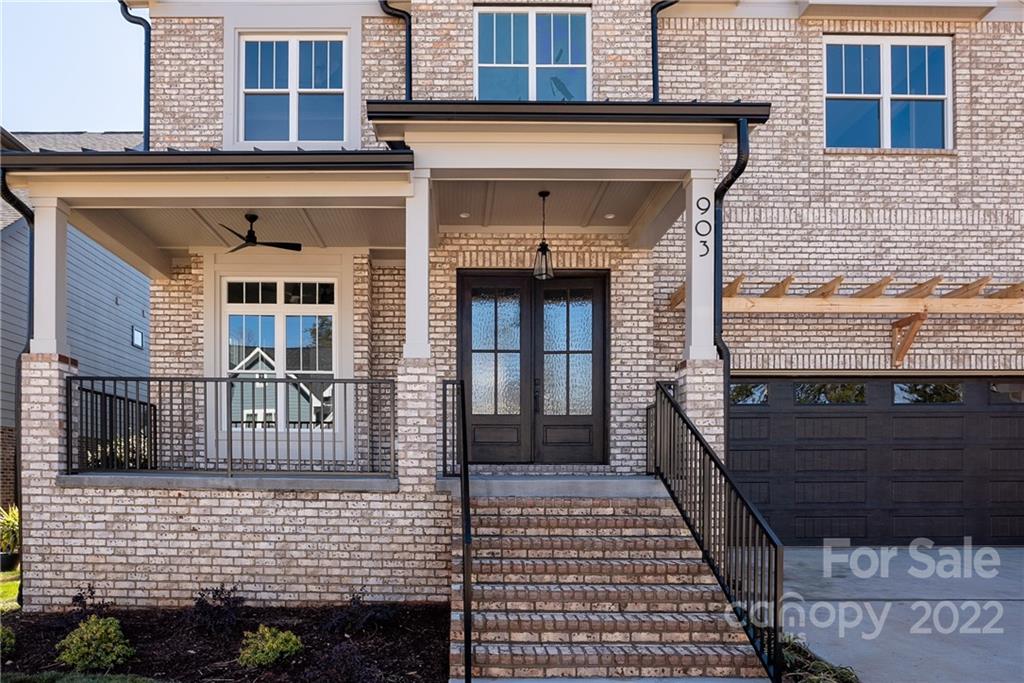 811 Naples Drive Davidson, NC 28036 - Photo 2 of 31 a view of a brick house with large windows
