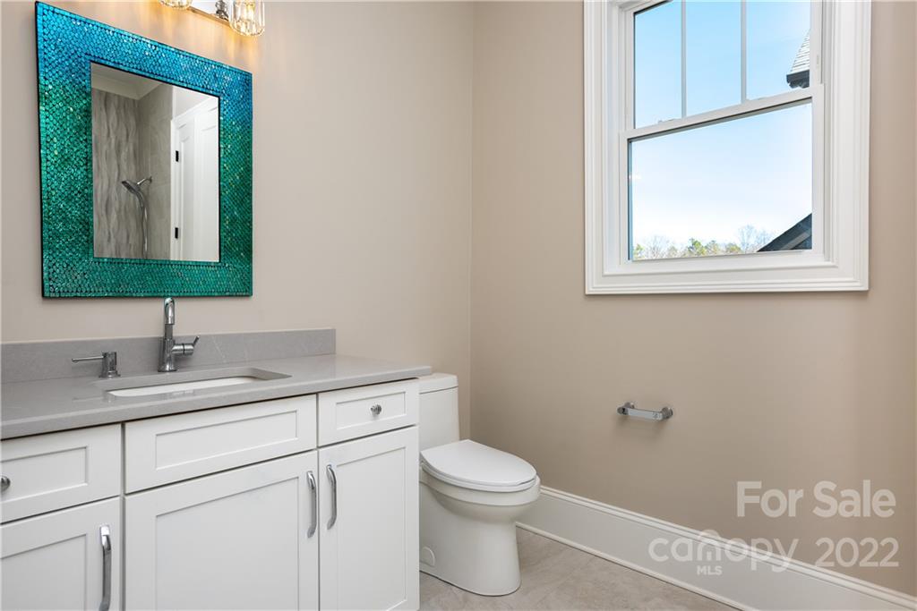 811 Naples Drive Davidson, NC 28036 - Photo 21 of 31 a bathroom with a toilet sink and mirror