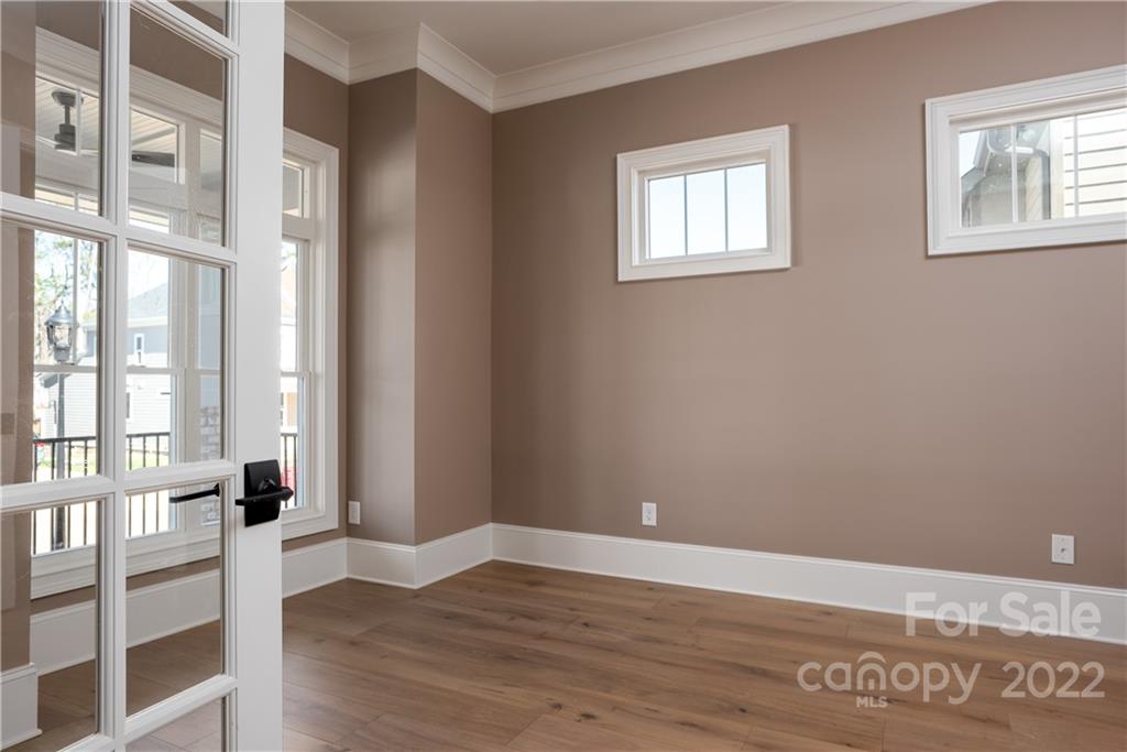 811 Naples Drive Davidson, NC 28036 - Photo 5 of 31 a view of an empty room with wooden floor and a window