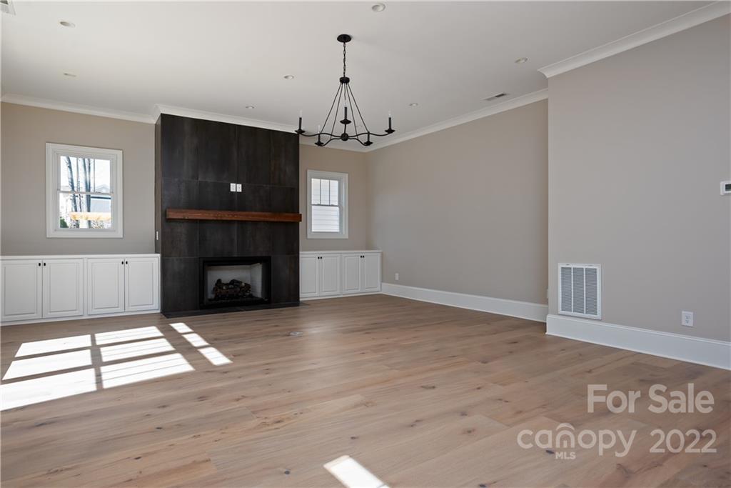 811 Naples Drive Davidson, NC 28036 - Photo 6 of 31 a view of an empty room with a fireplace and a window