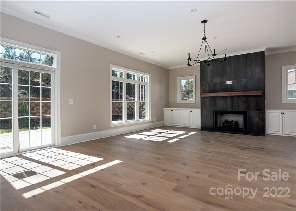 811 Naples Drive Davidson, NC 28036 - Photo 7 of 31 a view of an empty room with wooden floor and a window