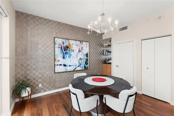 a view of a dining room with furniture and wooden floor