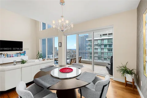 a view of a dining room with furniture wooden floor and chandelier