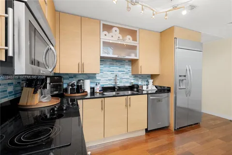 a kitchen with stainless steel appliances granite countertop a stove and a refrigerator