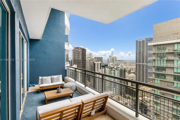 a view of roof deck with seating space and wooden floor
