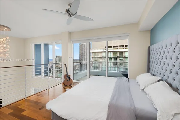a bed room with a bed and a large window