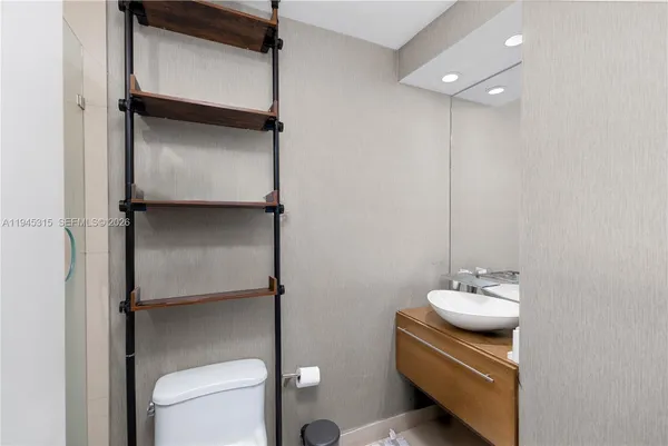 a bathroom with a toilet sink and mirror