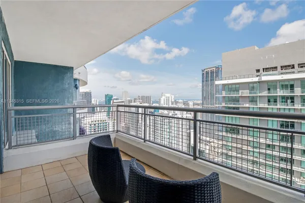 a view of roof deck with wooden fence and city view