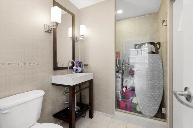 a bathroom with a sink toilet and shower