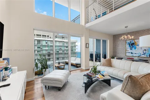 a living room with furniture or couch and a large window