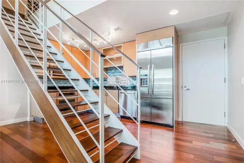 a view of entryway and hall with wooden floor