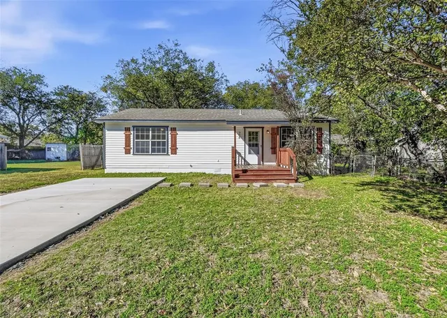 front view of a house with a yard