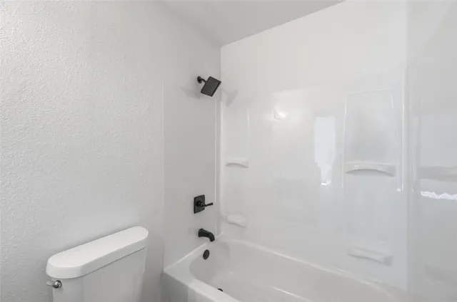 a bathroom with a toilet and a bathtub