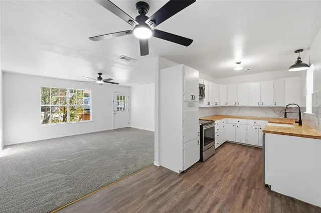 a kitchen with stainless steel appliances a stove a sink and a refrigerator