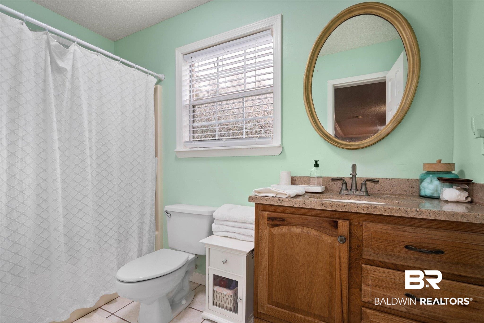 2300 Radcliff Road Saraland, AL 36571 - Photo 29 of 56 Bathroom featuring vanity, tile patterned floors, and curtained shower