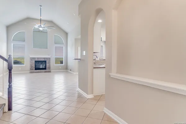 an empty room with fireplace and wooden floor