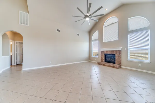 a view of an empty room with a fireplace and a window