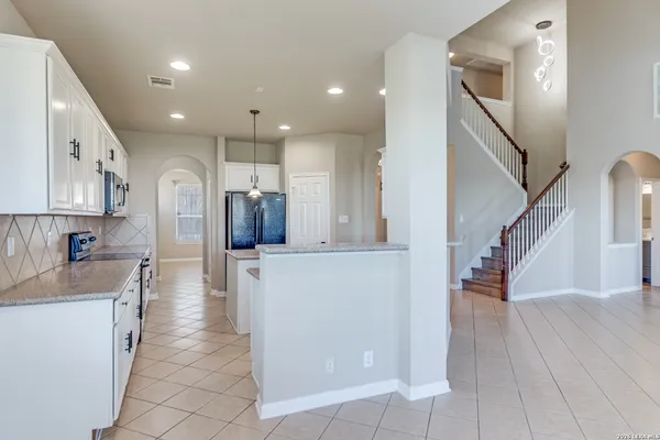 a view of a kitchen with cabinets and wooden floor