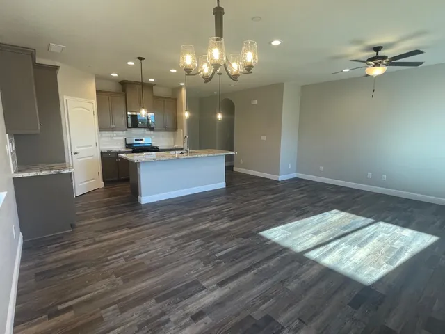 a view of kitchen and sink with large window