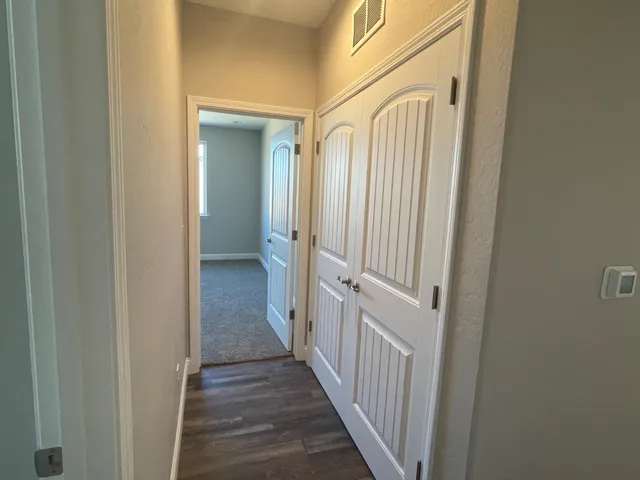 a view of a hallway with wooden floor