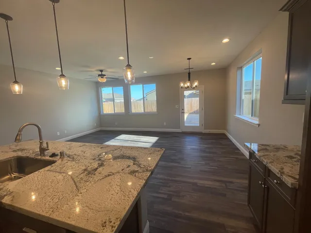a kitchen with kitchen island a sink stainless steel appliances and cabinets