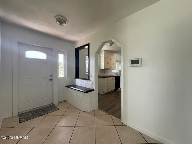a view of a bathroom with sink mirror and bathtub
