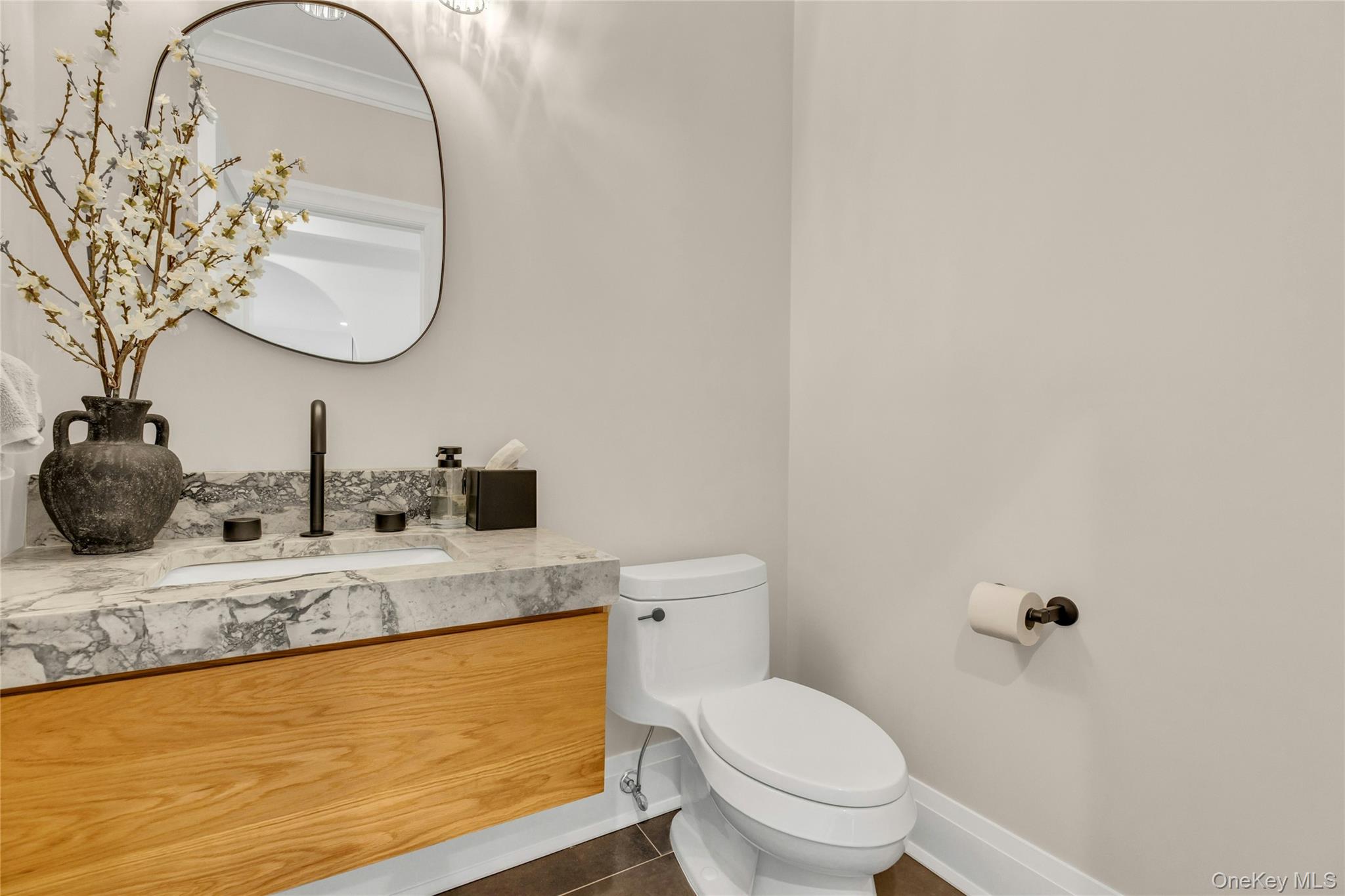 52 Concourse East Brightwaters, NY 11718 - Photo 21 of 49 a bathroom with a granite countertop toilet a sink and mirror