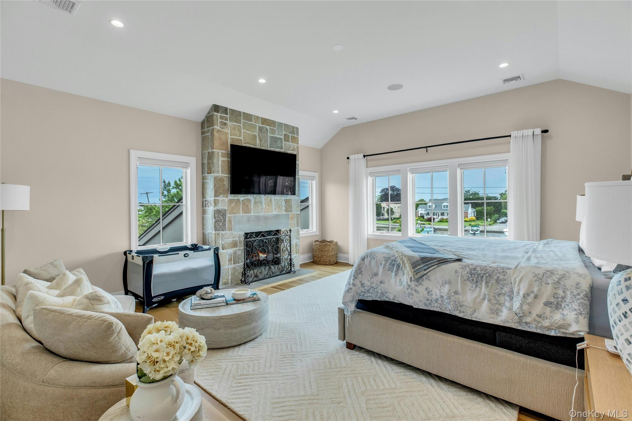 52 Concourse East Brightwaters, NY 11718 - Photo 25 of 49 a spacious bedroom with bed and a flat screen tv