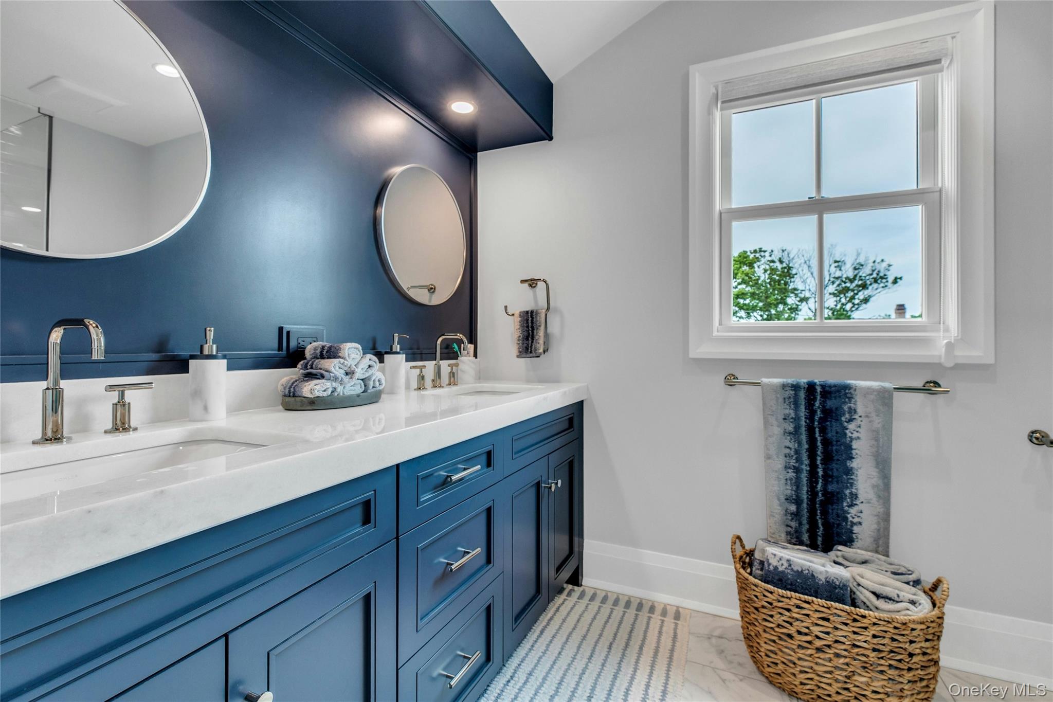 52 Concourse East Brightwaters, NY 11718 - Photo 35 of 49 a bathroom with a double vanity sink and a window