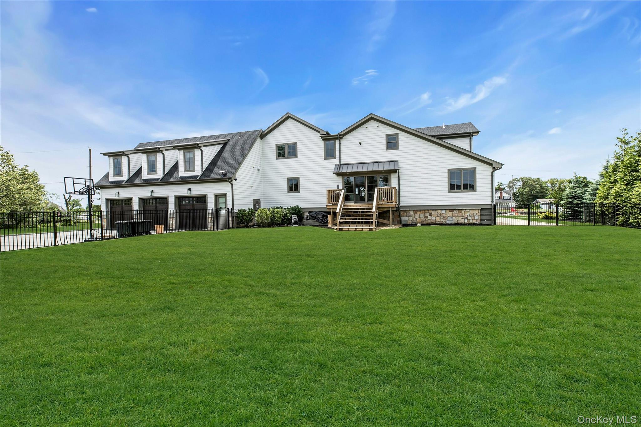 52 Concourse East Brightwaters, NY 11718 - Photo 42 of 49 a front view of house with yard and green space