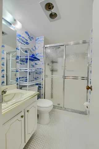a bathroom with a sink toilet and shower