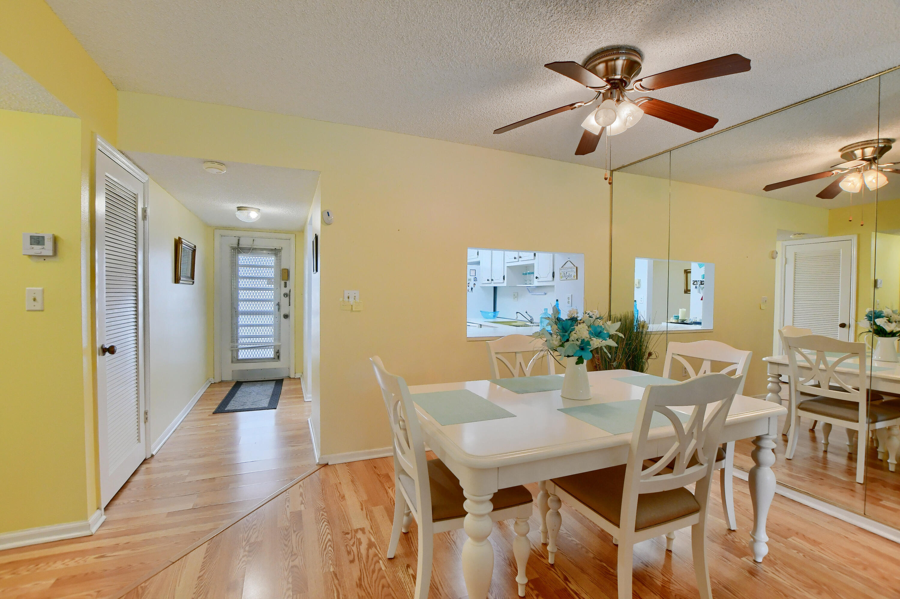 9826 Marina Boulevard, Unit 1027 Boca Raton, FL 33428 - Photo 5 of 25 a view of a dining room with furniture and wooden floor