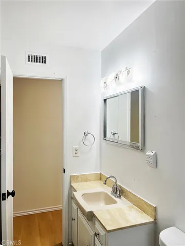 a bathroom with a sink vanity and a mirror