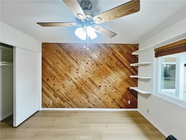 en empty room with window and wooden floor