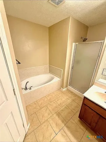 a bathroom with a tub and a shower
