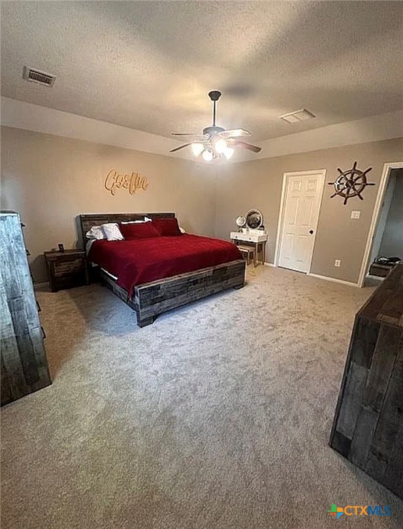 809 Buttercup Drive Edna, TX 77957 - Photo 14 of 16 a spacious bedroom with a bed and a chandelier