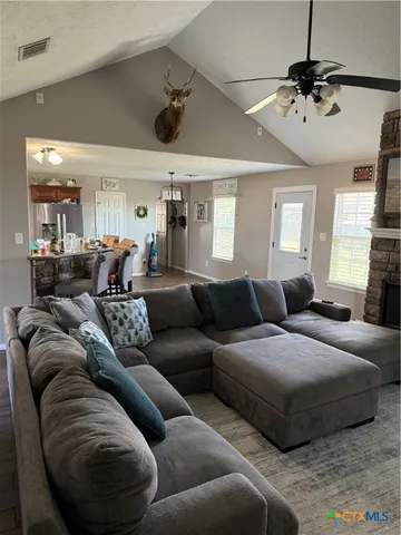 a living room with furniture and a chandelier