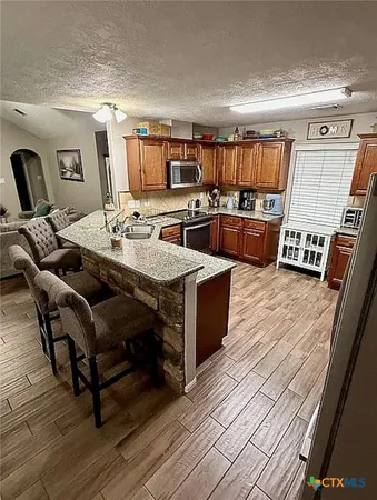a living room with lots of furniture and kitchen view