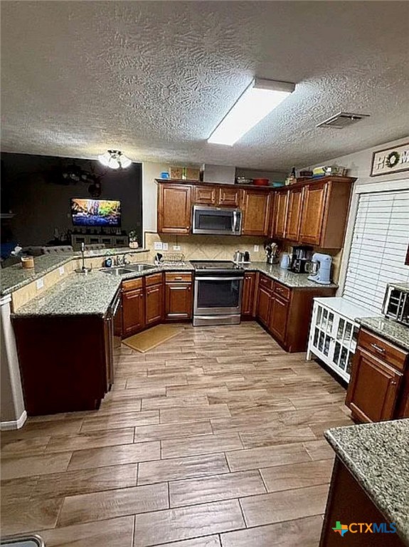 809 Buttercup Drive Edna, TX 77957 - Photo 9 of 16 a large kitchen with stainless steel appliances granite countertop a stove granite counter tops and white cabinets