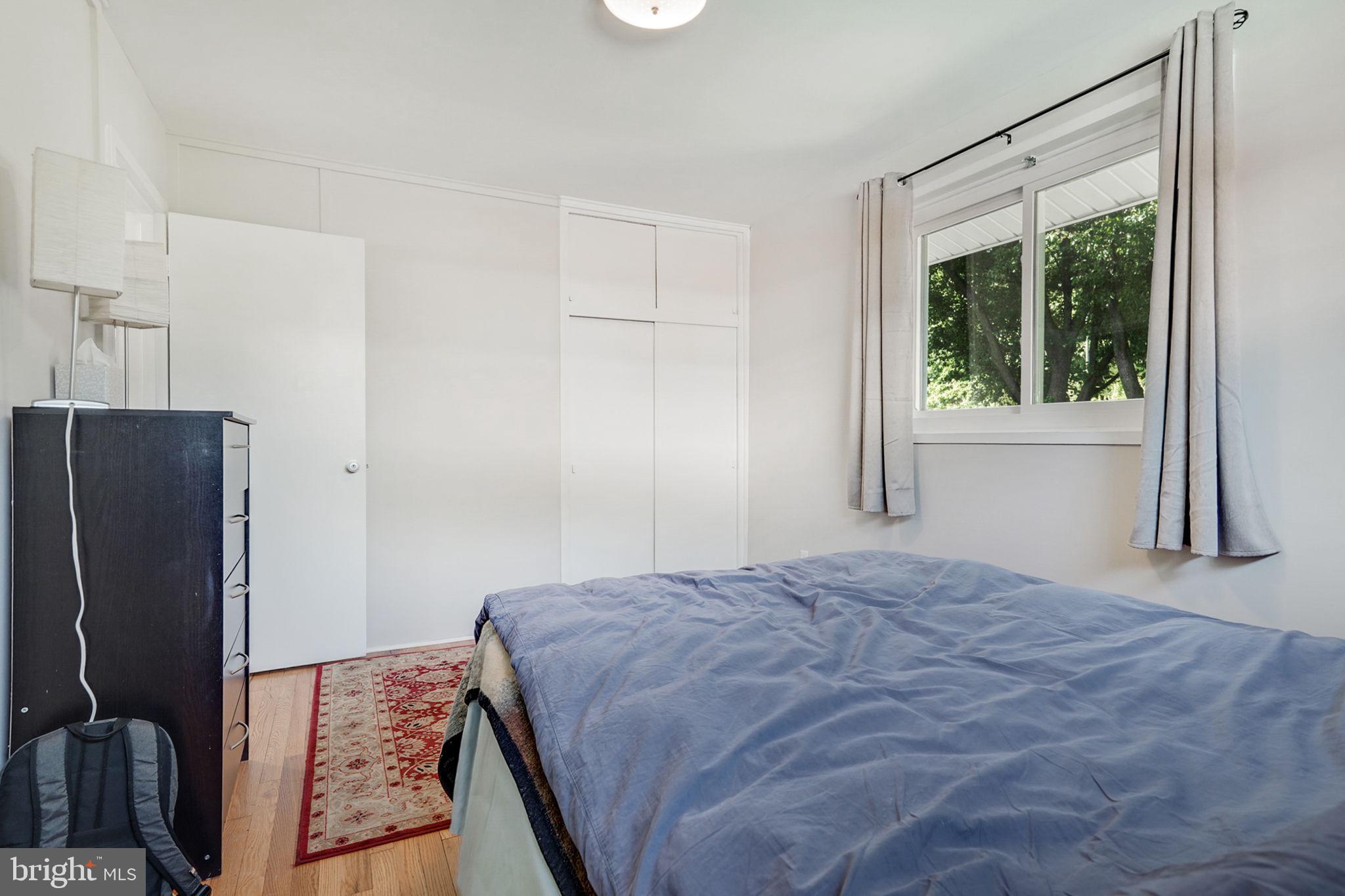 6369 Edsall Road Alexandria, VA 22312 - Photo 11 of 33 a bedroom with a bed mirror and a window