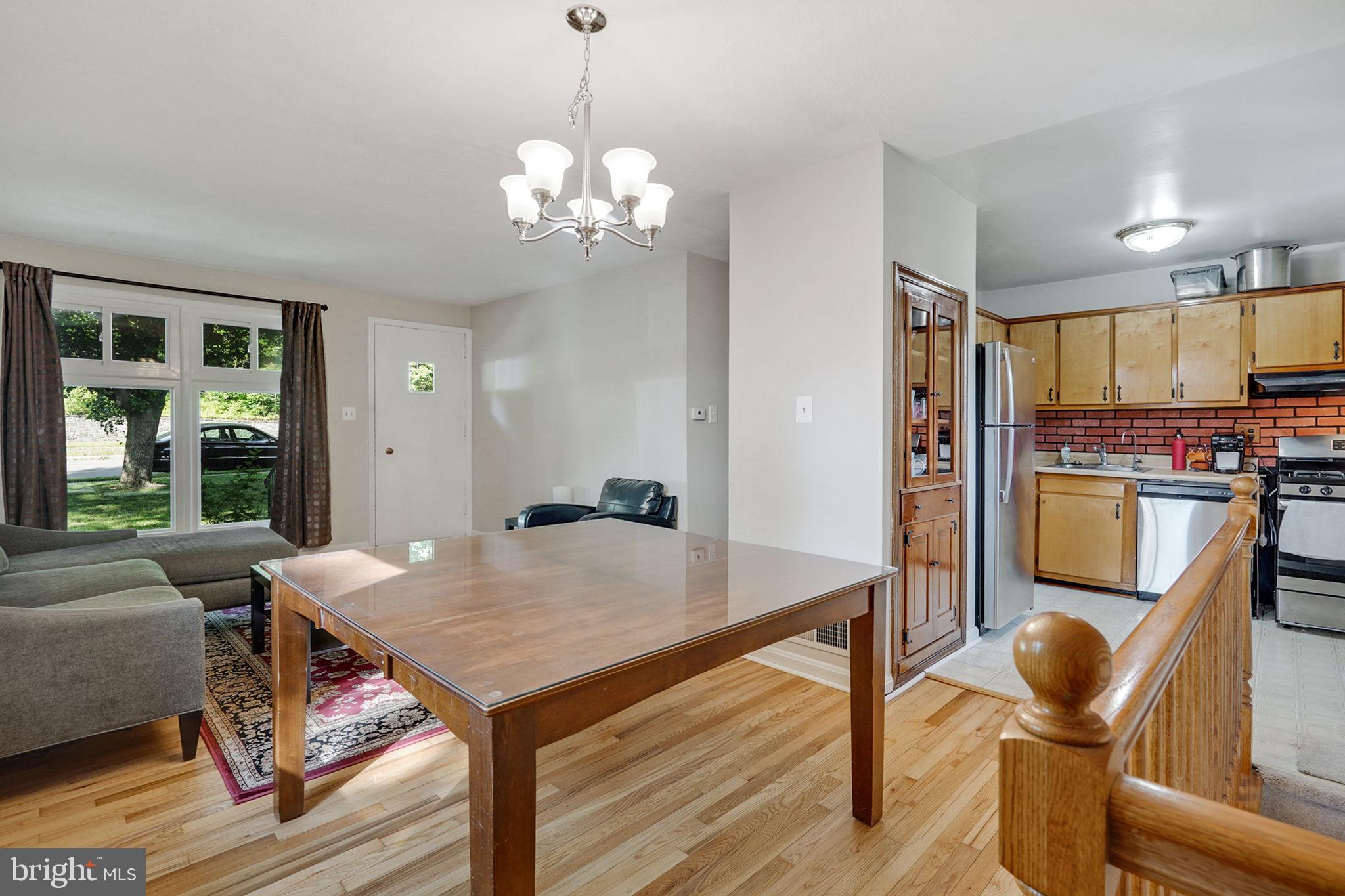 6369 Edsall Road Alexandria, VA 22312 - Photo 16 of 33 a view of a dining room with furniture a chandelier and wooden floor
