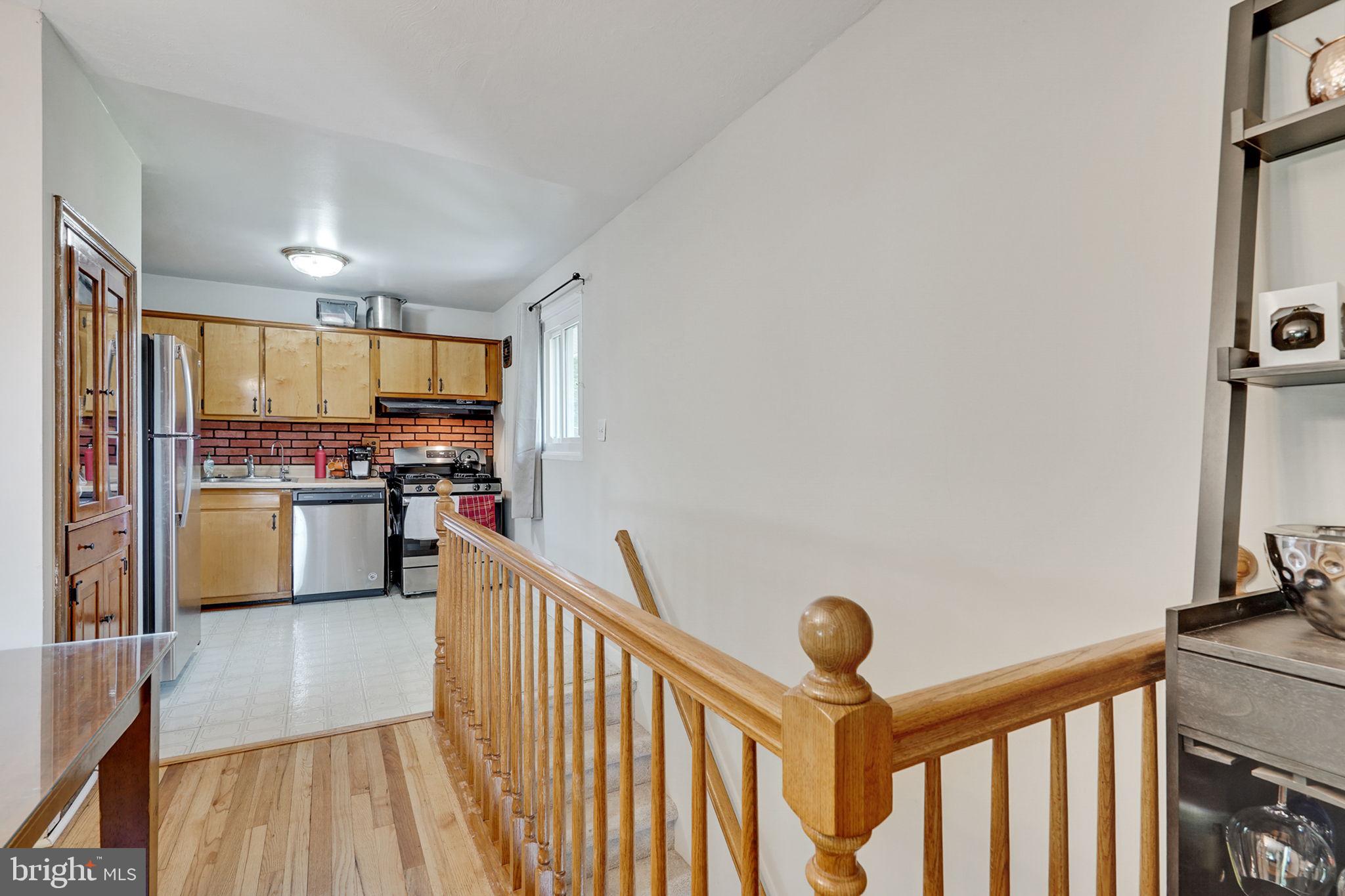 6369 Edsall Road Alexandria, VA 22312 - Photo 19 of 33 a kitchen with granite countertop a refrigerator oven a sink and white cabinets