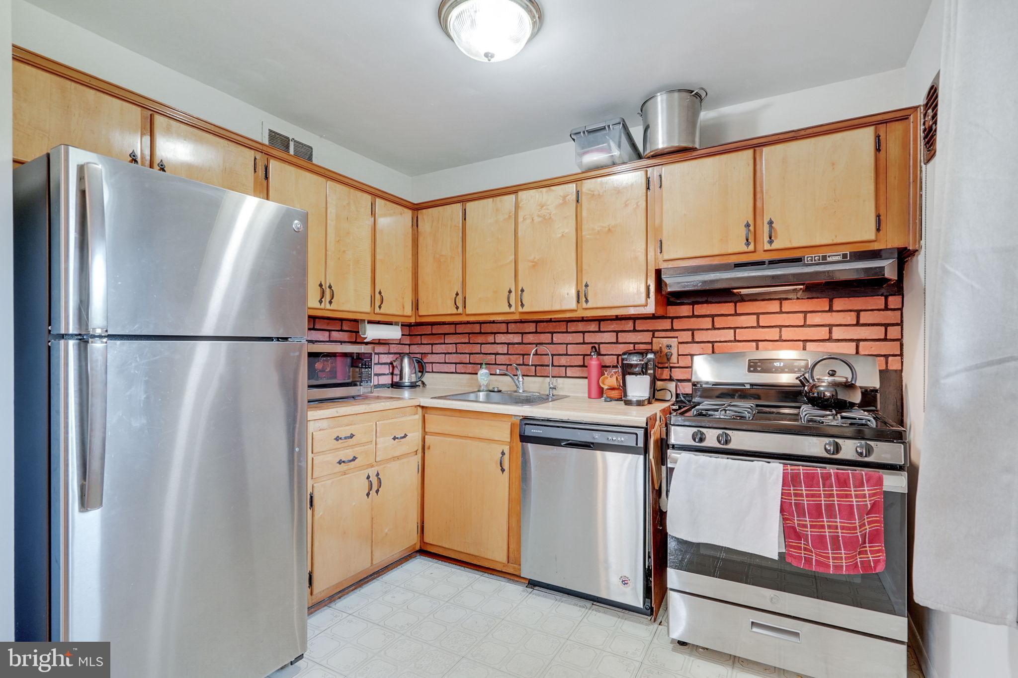 6369 Edsall Road Alexandria, VA 22312 - Photo 21 of 33 a kitchen with stainless steel appliances a refrigerator sink and cabinets