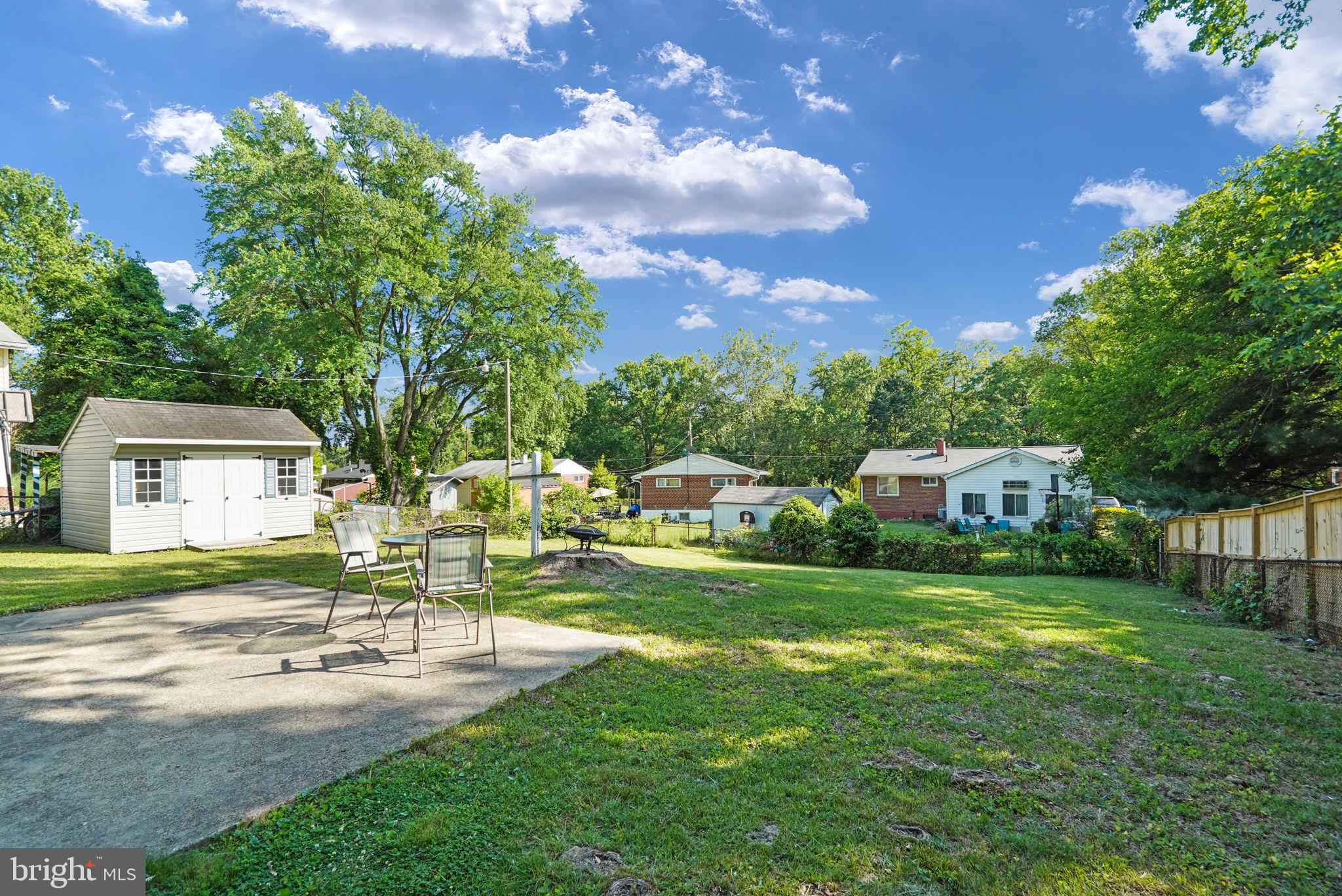 6369 Edsall Road Alexandria, VA 22312 - Photo 27 of 33 a front view of a house with a yard table and chairs
