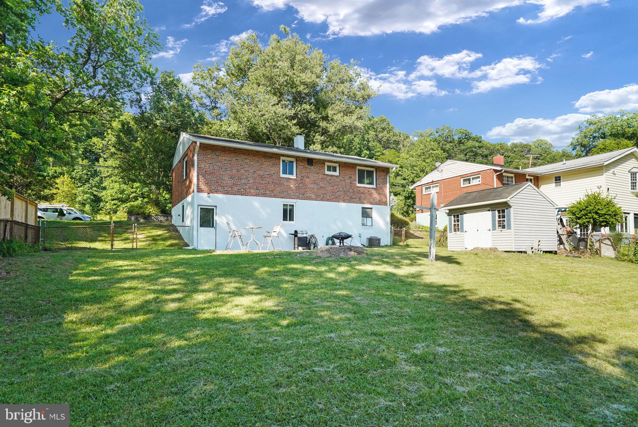 6369 Edsall Road Alexandria, VA 22312 - Photo 29 of 33 a front view of house with garden space and trees