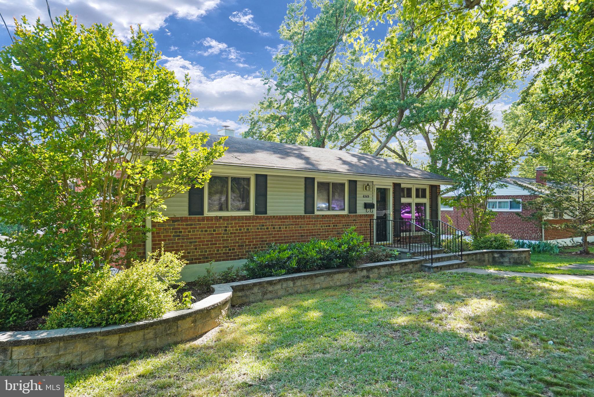 6369 Edsall Road Alexandria, VA 22312 - Photo 3 of 33 a front view of a house with a yard and large trees