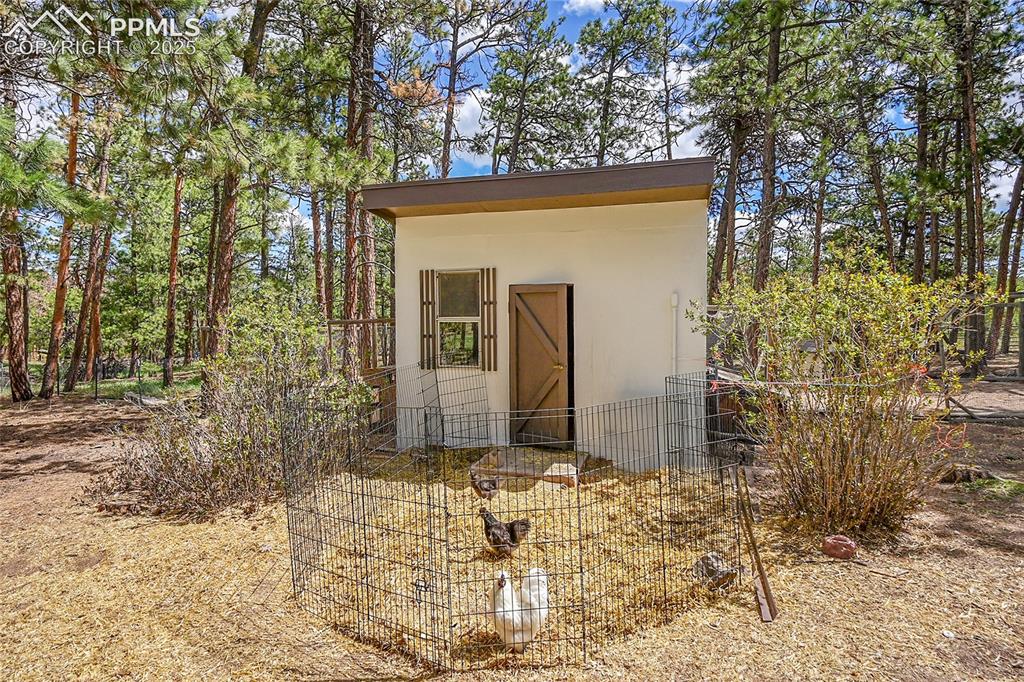 17350 Goshawk Road Colorado Springs, CO 80908 - Photo 41 of 50 a view of a house with a yard